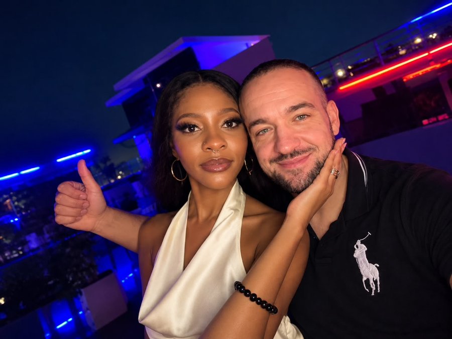 A couple smiling together at an evening event