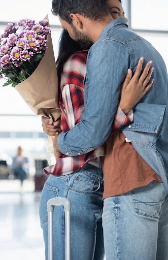 A couple embracing at an airport